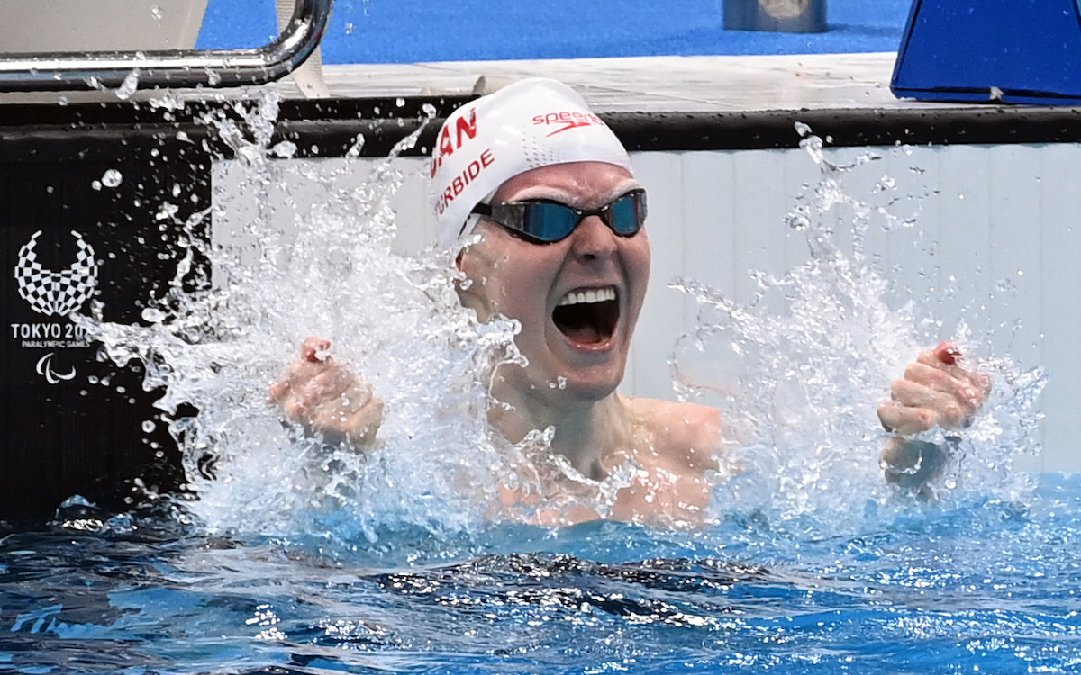 Nicolas-Guy Turbide celebrates in the pool after winning his first Paralympic silver medal, in the men’s 100m backstroke S13