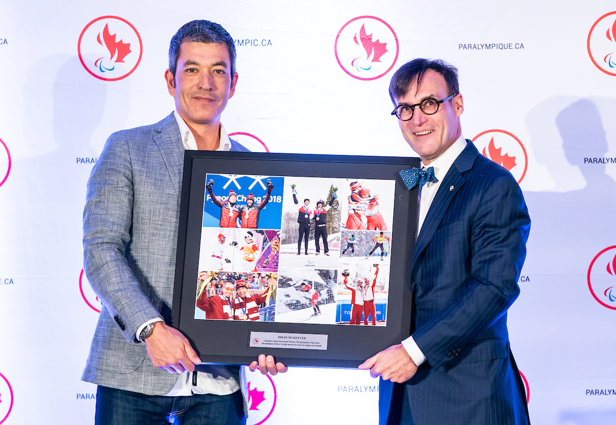 Robin McKeever accepting a framed photo of Nordic athletes from CPC President Marc-Andre Fabien