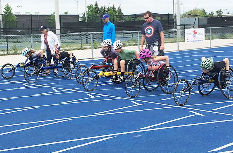 Kids in racing chairs at a start line