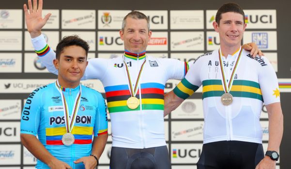 Tristen Chernove, centre, with his gold medal from the 2018 Para cycling road world championships. 