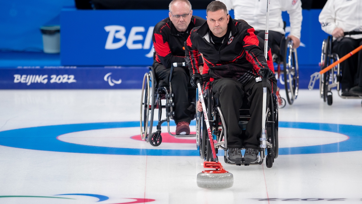 Mark Ideson preparing to take a shot in wheelchair curling 