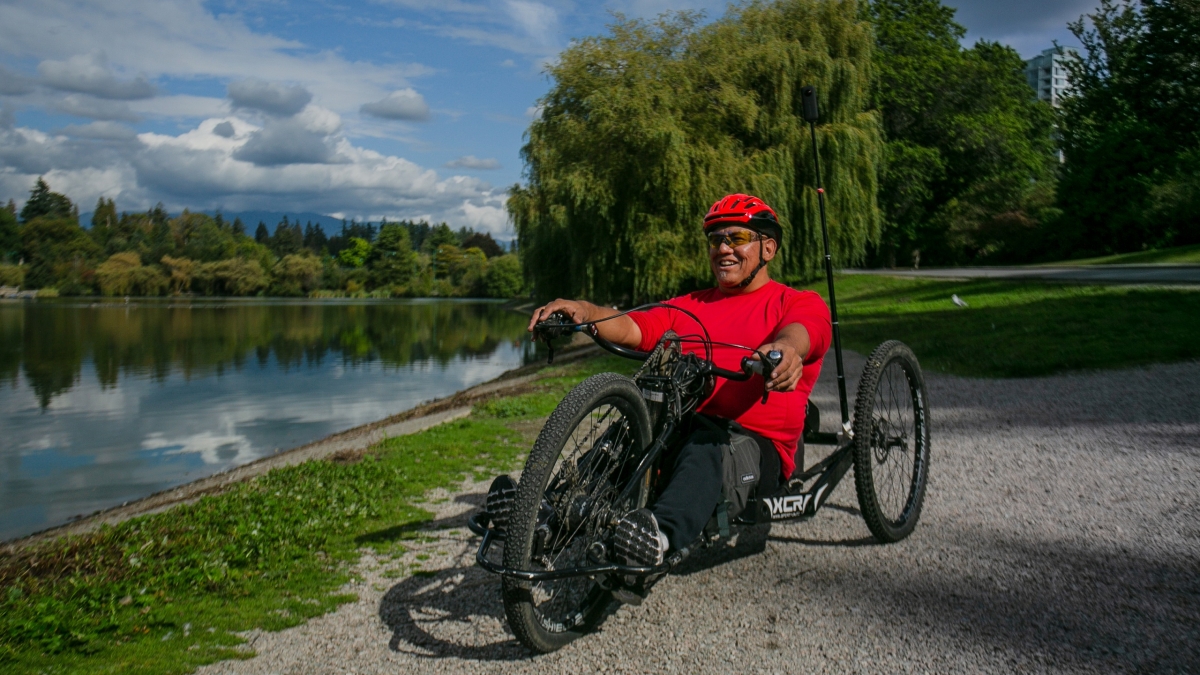 Richard Peter hand cycling in Stanley Park in Vancouver