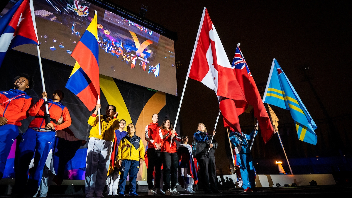 The flag bearers for the Lima 2019 Parapan Am Games stand together at the Closing Ceremony