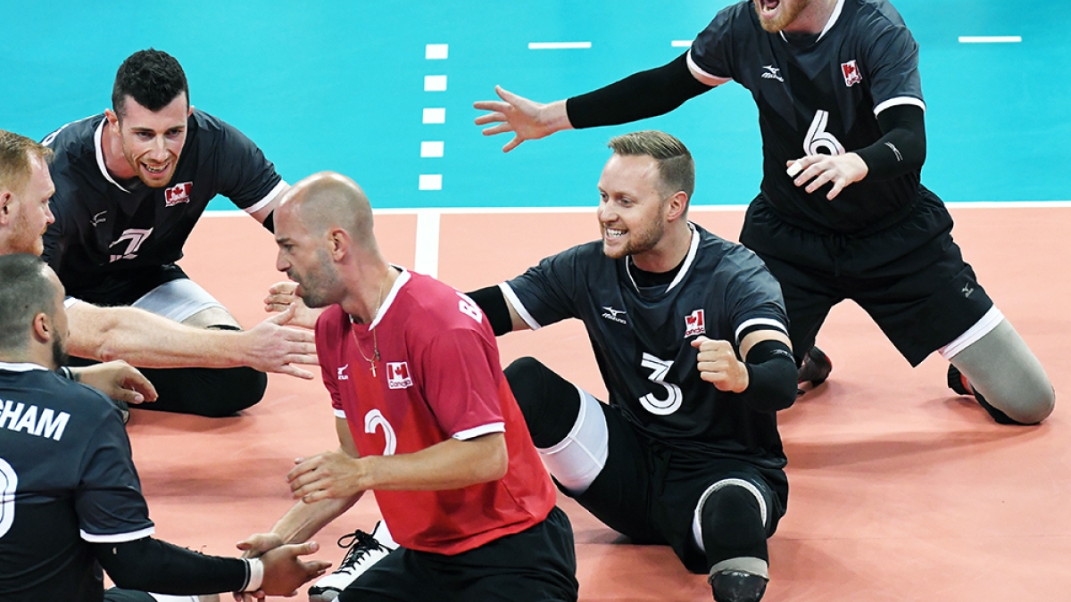 Sitting Volleyball celebrating a win on court 