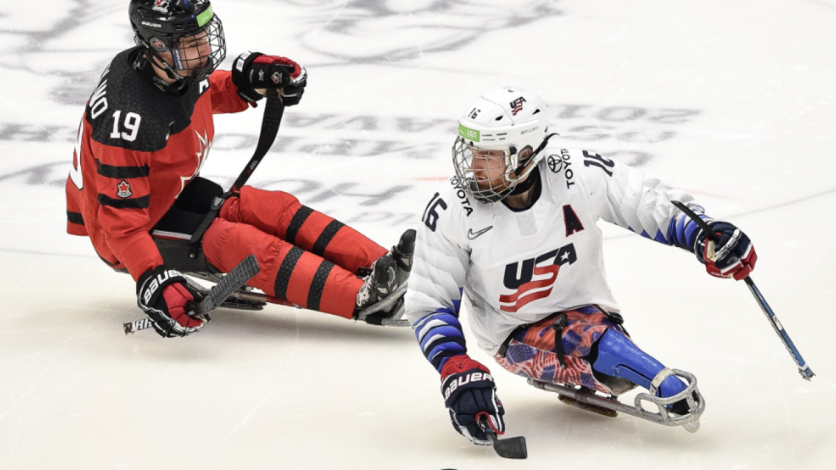 Dominic Cozzolino and an American player on the ice at the 2019 World Para Ice Hockey Championships