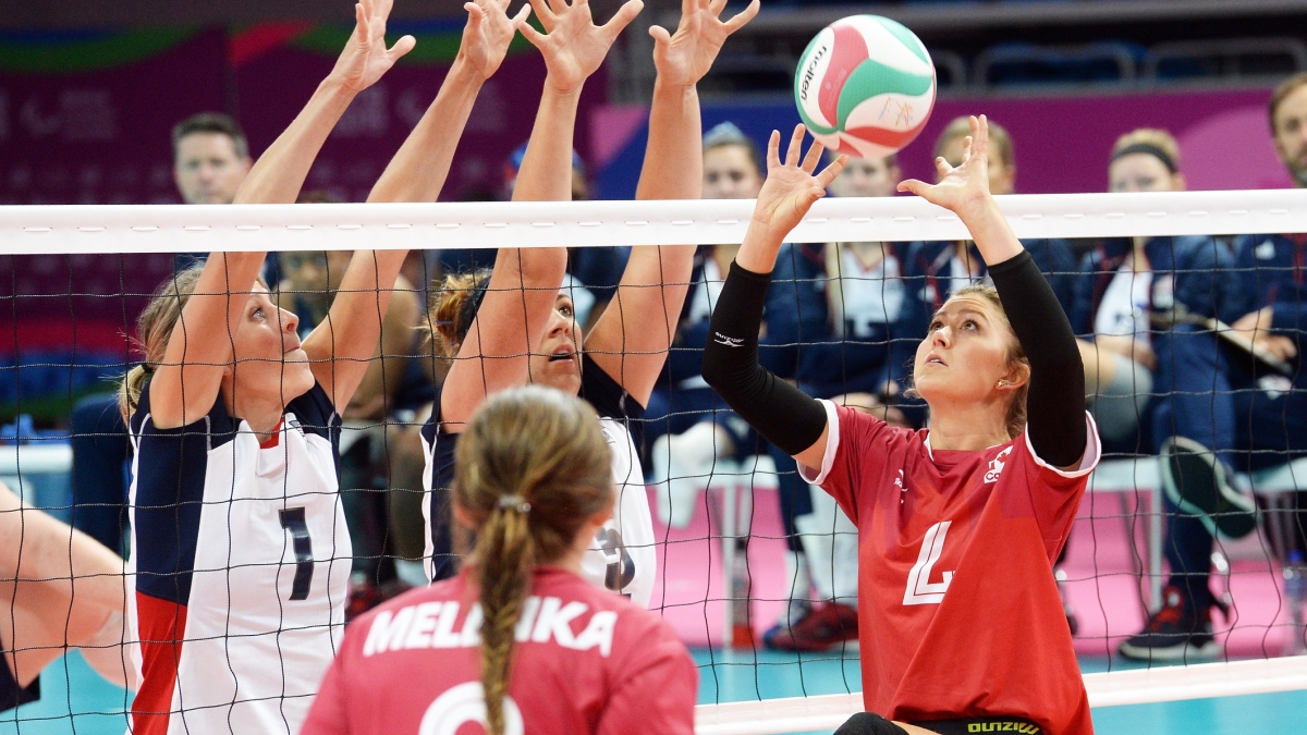 Jennifer Oakes of the Canadian women's sitting volleyball team volleys the ball. 