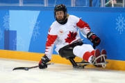 Adam Dixon with the puck in action at the PyeongChang 2018 Paralympic Winter Games