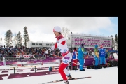 Caroline skiing in front of the stands