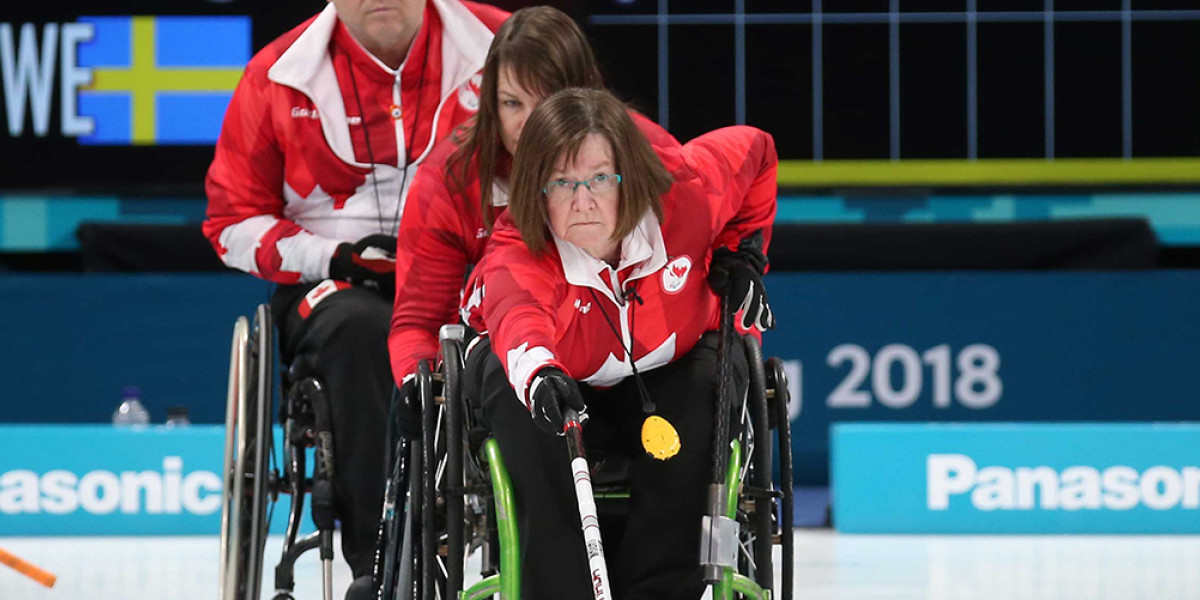 Marie Wright pushing the rock in wheelchair curling