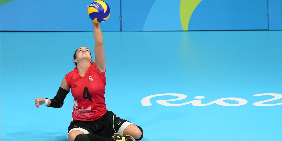 Shacarra playing sitting volleyball