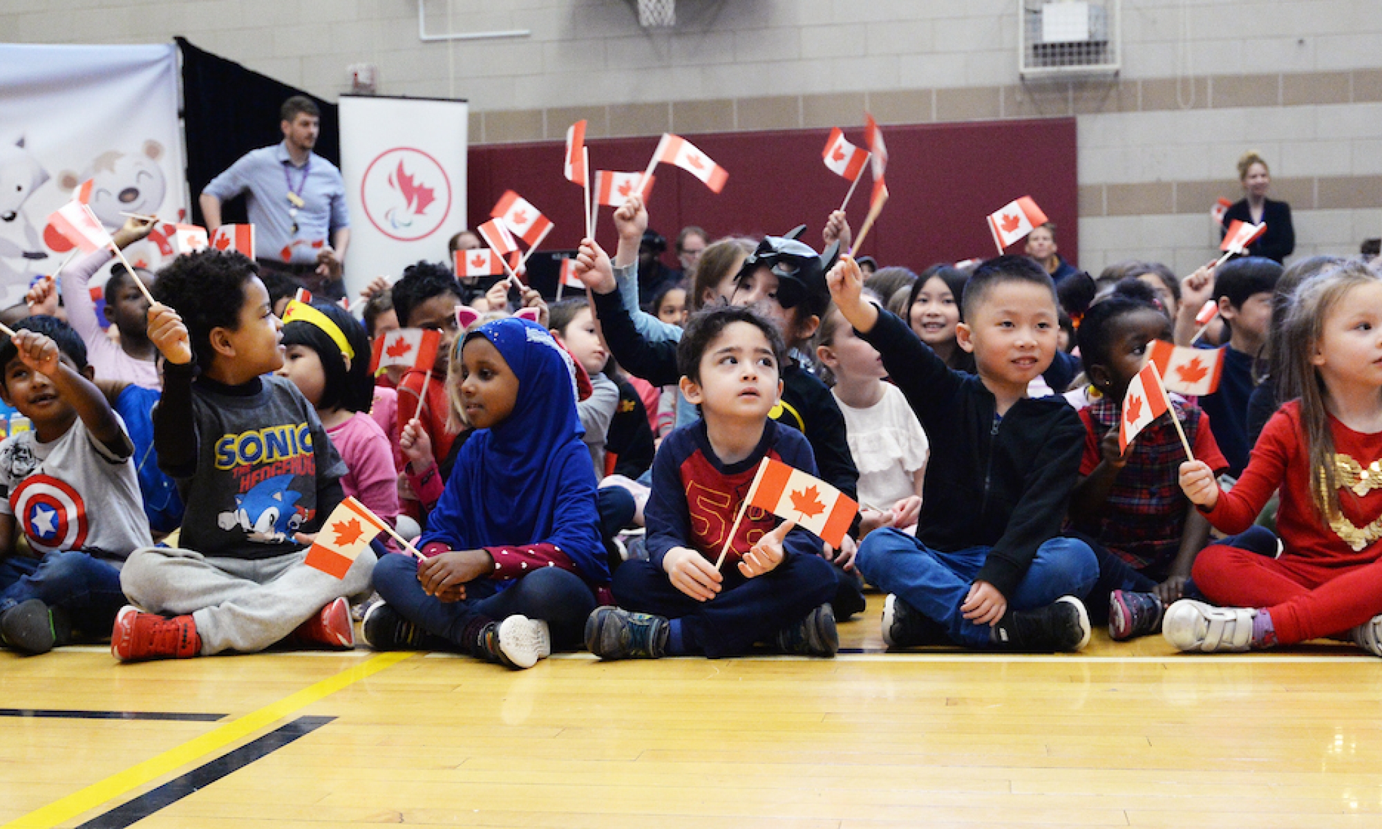 Kids waving Canadian flags