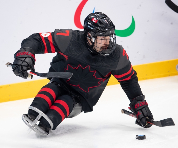 Zach Lavin with the puck in Para ice hockey action at Beijing 2022 Paralympic Winter Games