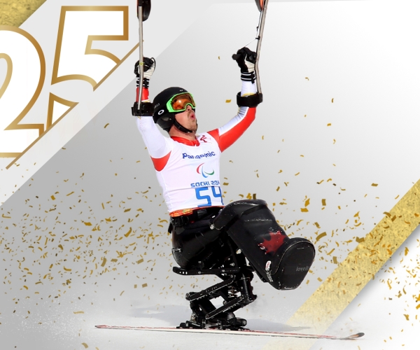 Sit skier Josh Dueck with his arms in the air celebrating after winning at the Sochi 2014 Paralympic Winter Games. 