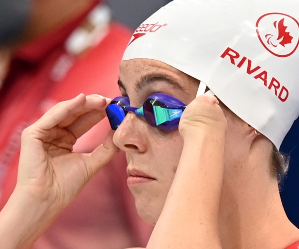 A close-up of Aurelie Rivard adjusting her googles in preparation for a race at Tokyo 2020