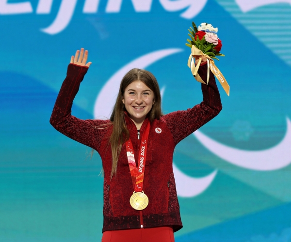 Mollie Jepsen smiling with her gold medal in the downhill at Beijing 2022 Paralympic Winter Games