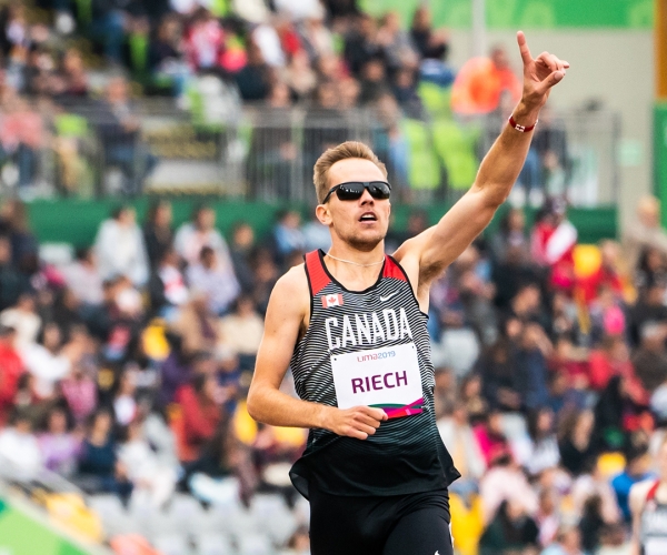 Nate Riech celebrates after winning the gold medal in men's 1500m