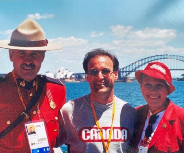 CPC president Marc-André Fabien with Senator Joyce Fairbairn and a RCMP Mountie at the Sydney 2000 Paralympic Games with the Sydney Bridge in the background