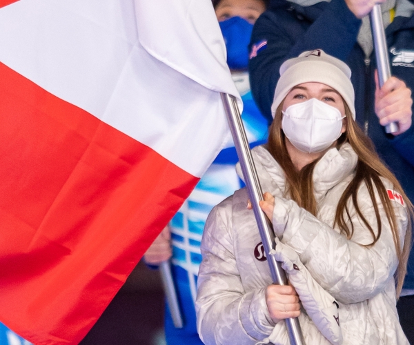 Mollie Jepsen carries the flag at the Beijing 2022 Closing Ceremony