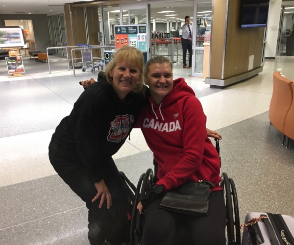 Monica (Nikita's mom) and Para swimmer Nikita Ens together at the airport. 