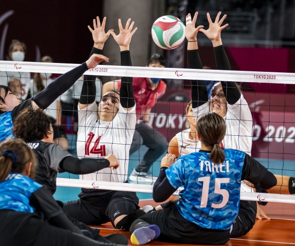 Katelyn Wright (L) and Heidi Peters (R) blocking the ball in sitting volleyball action at the Tokyo 2020 Paralympic Games