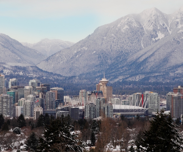 A scenic landscape shot of downtown Vancouver with the mountains in the background