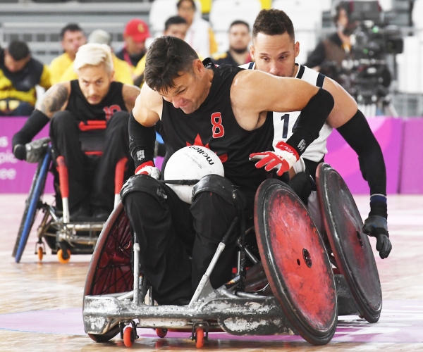 Mike Whitehead with the ball in wheelchair rugby action at the Lima 2019 Parapan Am Games. 
