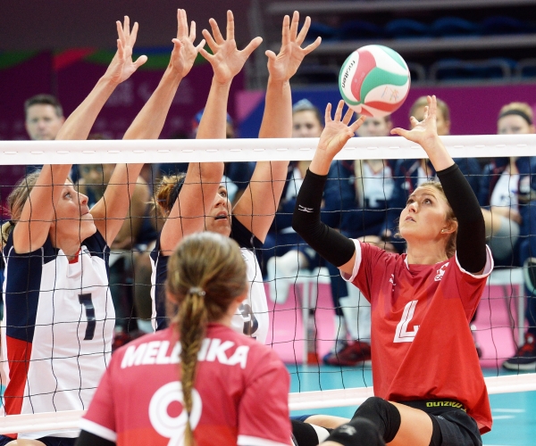 Jennifer Oakes of the Canadian women's sitting volleyball team volleys the ball. 