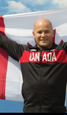 David Eng holding the Canadian flag
