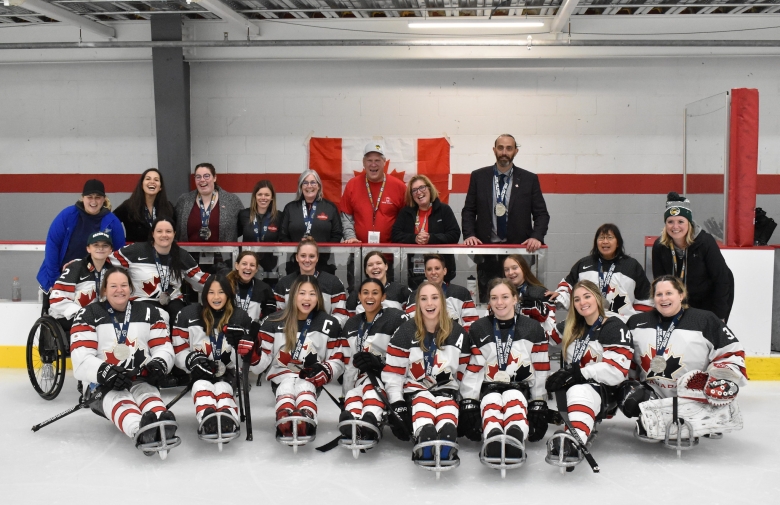 Canada's women's Para ice hockey team smiling with their silver medals at the World Challenge