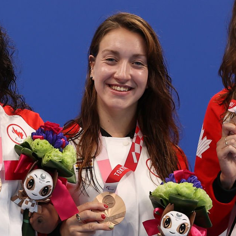 Canadian Para swimmer Sabrina Duchesne wearing a bronze medal on the podium at the Tokyo 2020 Paralympics.