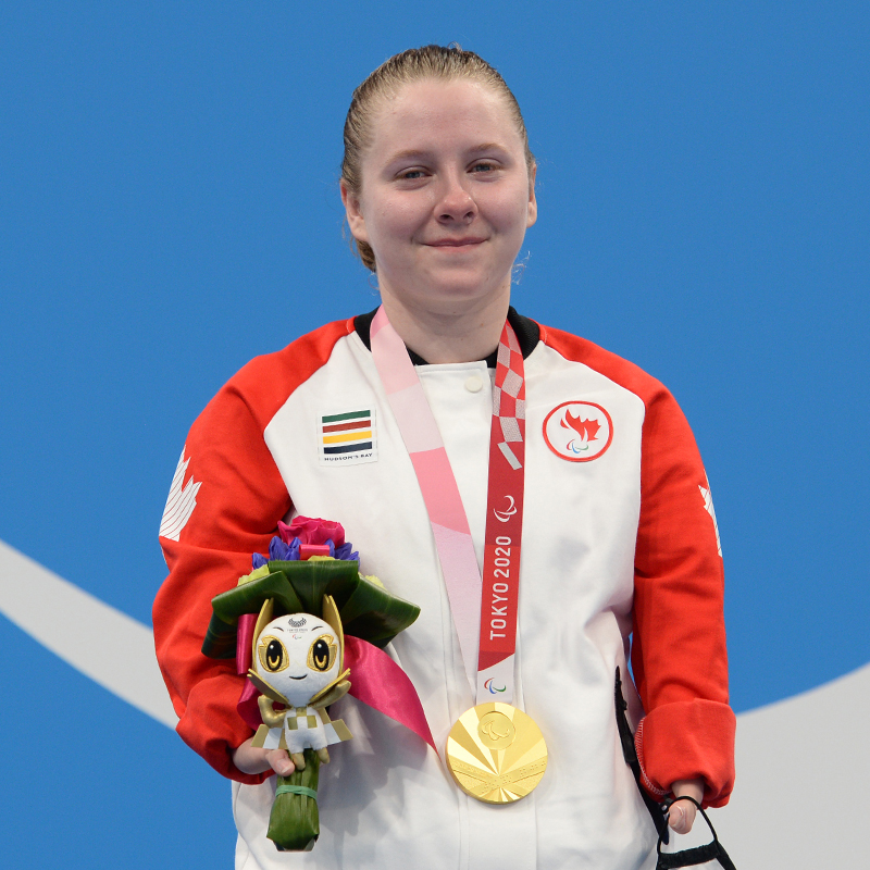 Canadian Para swimmer Danielle Dorris wearing her gold medal on the podium at the Tokyo 2020 Paralympics.