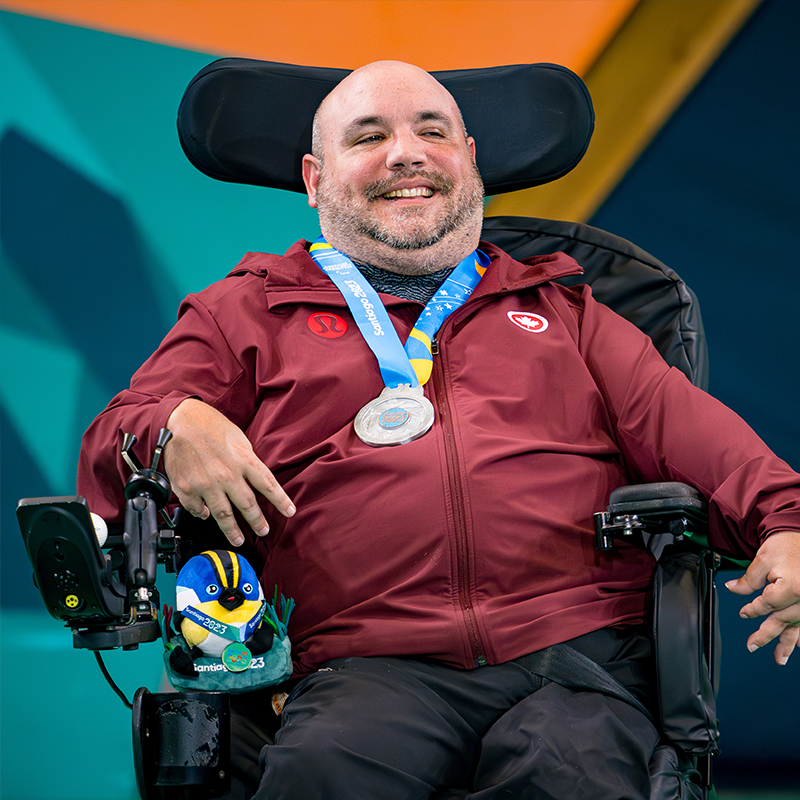 Canadian Boccia player Lance Cryderman smiles as he proudly wears his silver medal from the Santiago 2023 Parapan American Games.