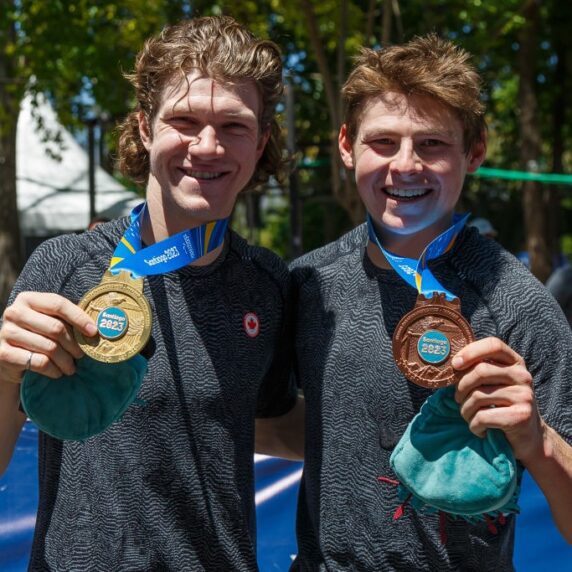 Alexandre Hayward and Mike Sametz showing off their gold and bronze medals with smiles
