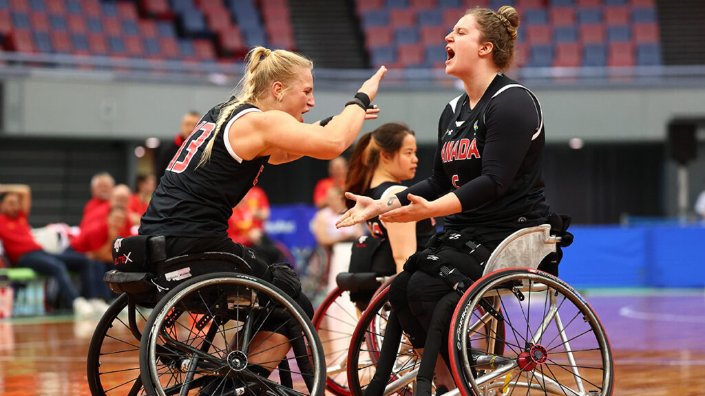 Kady Dandeneau and Arinn Young exchanging high fives during the game.