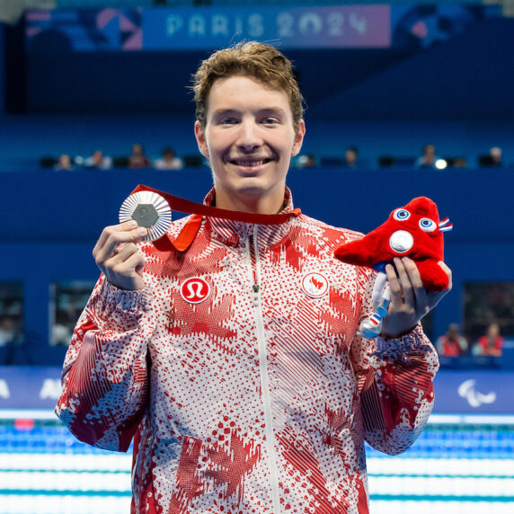 Nicholas Bennett holds up his silver medal