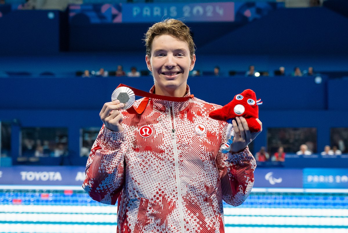 Nicholas Bennett holds up his silver medal