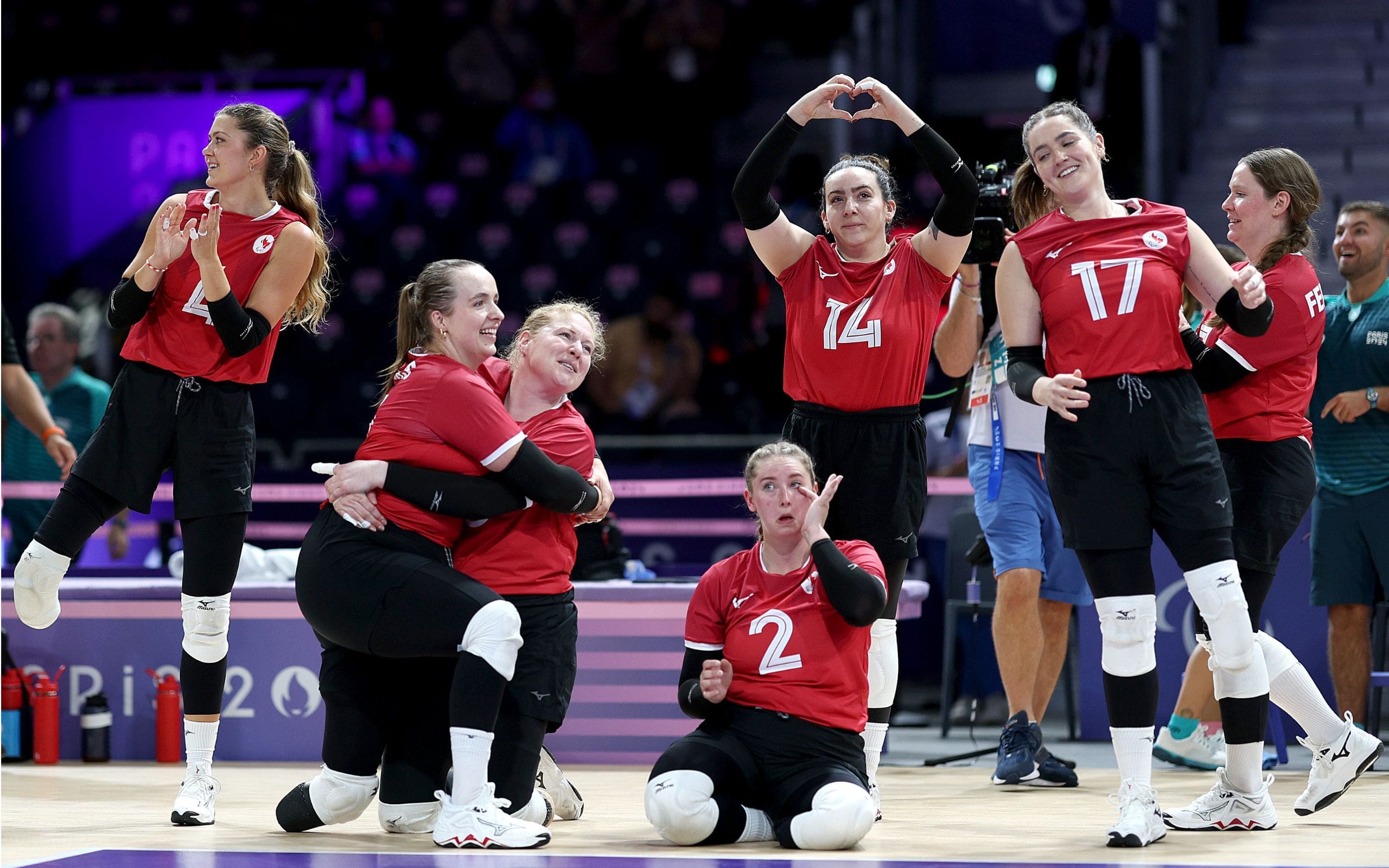 Team Canada Women's sitting volleyball team celebrate after victory against Slovenia