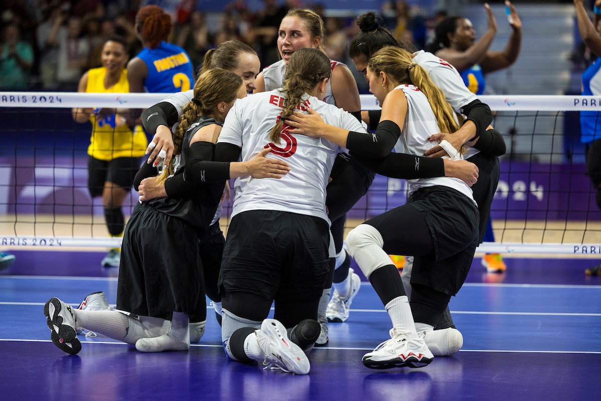 Canada's sitting volleyball team huddled after a point.