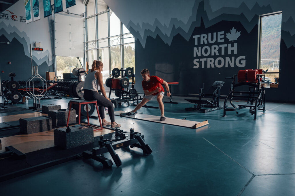 Kalle Eriksson and Sierra Smith train in a gym