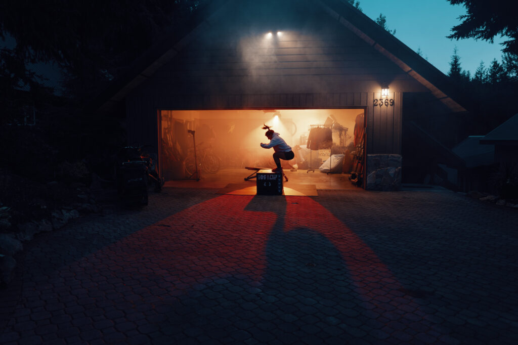 Mollie Jepsen does box jumps outside of her garage